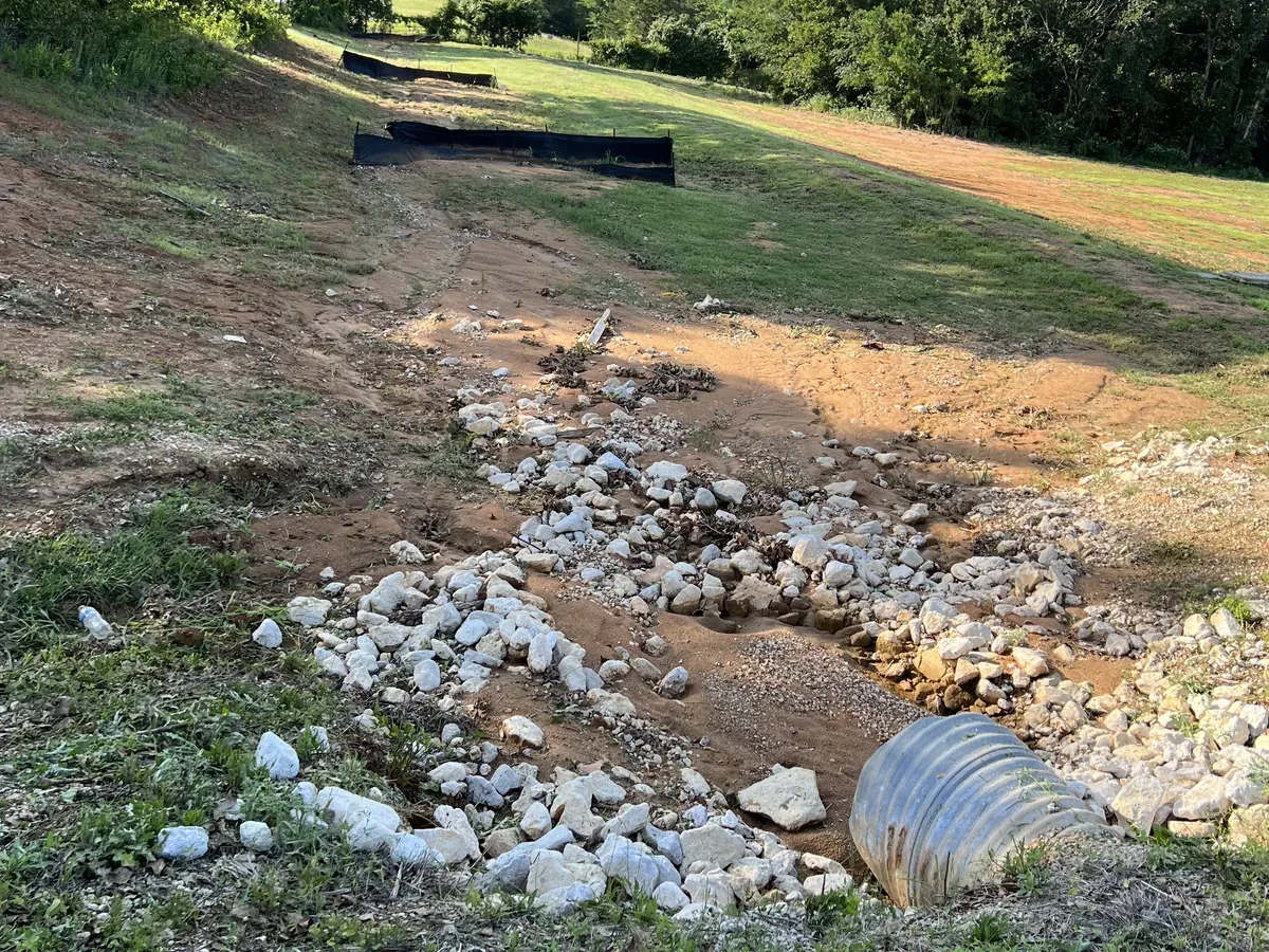 Rock lined drainage channel with a culvert pipe outlet