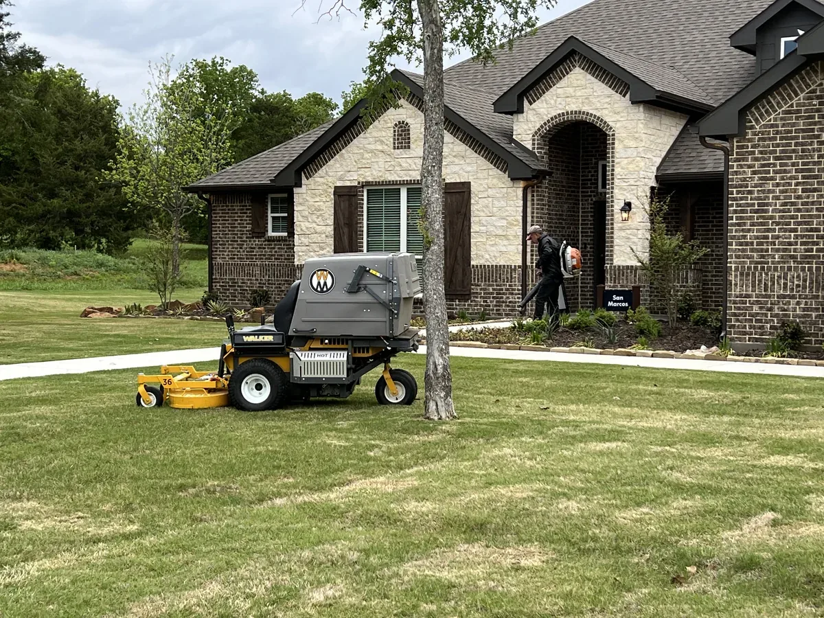 Zero turn mower parked on a mowed lawn at a new construction home